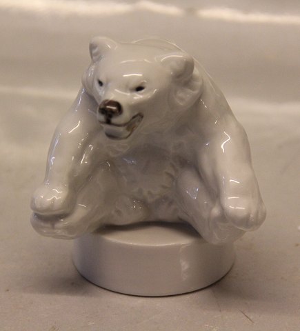 Royal Copenhagen Art Pottery 22746 RC Polar bear cub sitting with paw to paw on 
round base 10 x 9 cm  (# 1049246) 10 cm, Jeanne Grut,  May 1982 (0346)