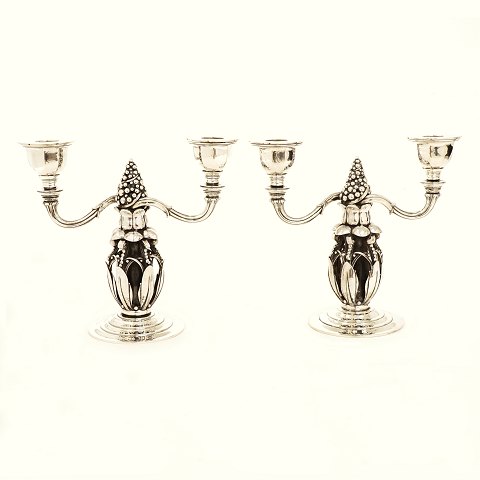 A pair of two light Georg Jensen candelabra, 
sterlingsilver. #244. Made in the period 
1925-1932. Dated 1931. H: 21,2cm. B: 23,5cm. W: 
2.849gr