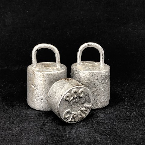 A set of three old weights
