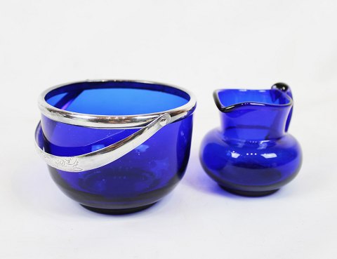 Sugar bowl decorated with silver handle and cream jug both of dark blue glass by 
Holmegaard in the 1930s.
5000m2 showroom.