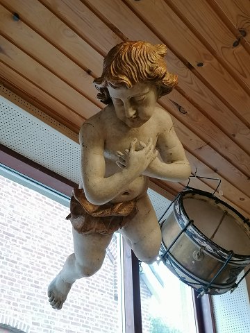 Large putto of carved and painted wood