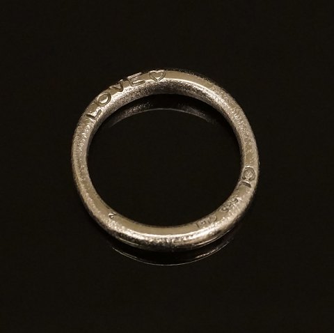 Charlotte Lynggaard, Copenhagen: A 14kt whitegold 
"Love" ring. Ringsize: 54