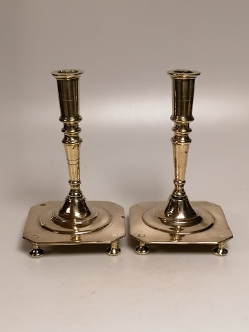 A pair of brass stays on a square base for the 
18th century.
