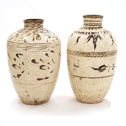 A pair of large cream glazed Citzhou Jars. China 
circa 1700-50. H: 68 & 73cm