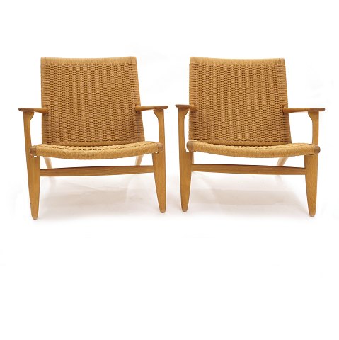 Pair of Hans Wegner's CH 25 armchairs in a very 
nice condition. Patinated oak. H: 71cm. W: 70cm