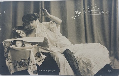 Postcard: Young woman reading the morning paper in 1909