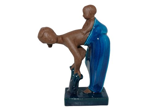 Royal Copenhagen art pottery figurine
Woman with child on back by Johannes Hedegaard