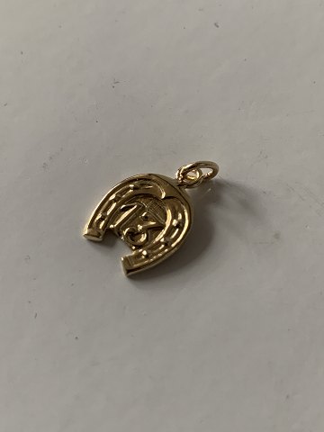 Charm for bracelet in 14 carat gold and shaped like a horseshoe. Stamped 585.