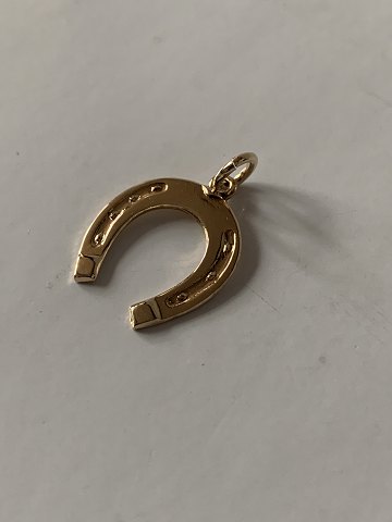 Horse shoe as a pendant/charm in 14 carat gold, stamped 585