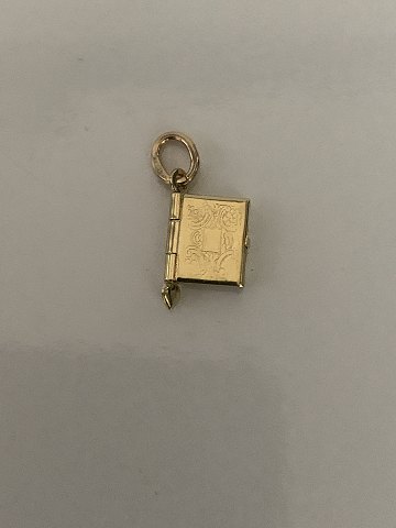 Charm i 14 karat guld, og formet som en lille bog. Stemplet 585