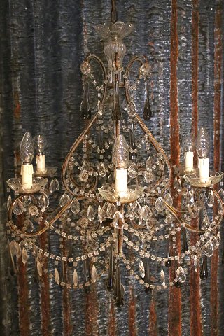 Old French prism chandelier, decorated with lots of clear glass prisms, chains 
and glass beads...