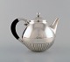 Johan Rohde for Georg Jensen. "Kosmos" teapot in sterling silver with ebony 
handle. Design 45A.