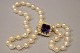 A pearl chain with cultured pearls, gold clasp with an amethyst