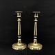 A set of tall brass candleholders
