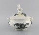Early Royal Copenhagen Blue Flower Curved lidded tureen in porcelain with 
hand-painted flowers. Lid modeled with fruit-eating putti. Approx. 1820
