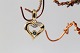Heart-shaped pendant in 14 carat gold, with diamonds and a blue sapphire in the middle. Very elegant.Stamped 585 SIS