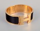 Hermes, France.
Clic Clac H bracelet. Gold-plated metal and enamel.