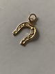 Horse shoe as a pendant/charm in 14 carat gold, stamped 585