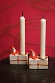 Old Santa Claus candlesticks in porcelain of a little Santa sitting on a 
Christmas package...