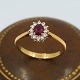 Ring in 18k gold set with a ruby and diamonds