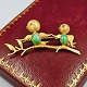 Broche med 
fugle i 14 kt. 
guld med jade 
og rubin