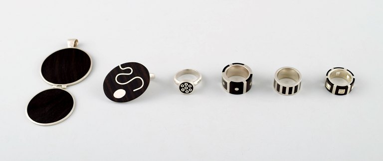 Collection of jewelry in sterling silver, most with mountings of ebony, 
consisting of five rings and a pendant.