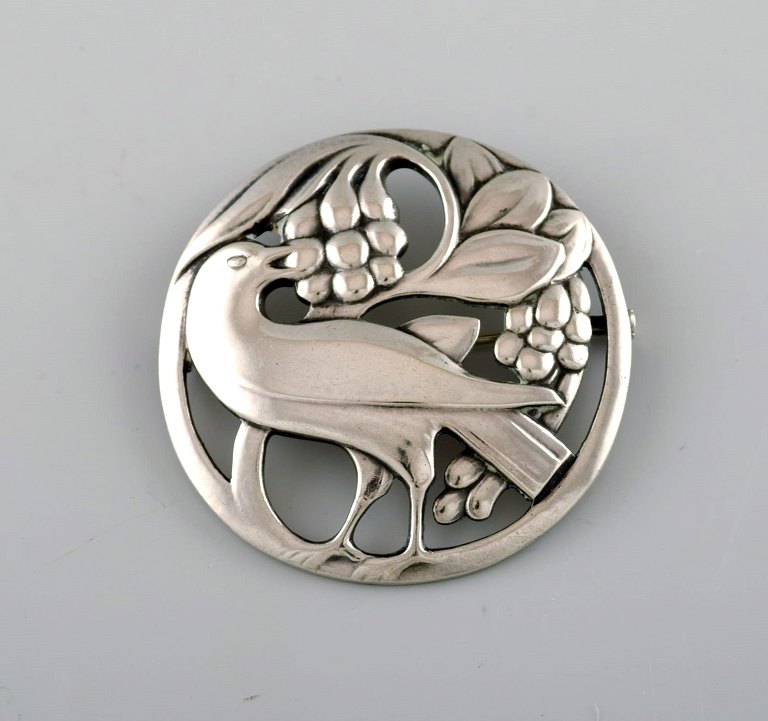 Early Georg Jensen brooch in sterling silver. Design number 53. Bird motif and 
grapes.
