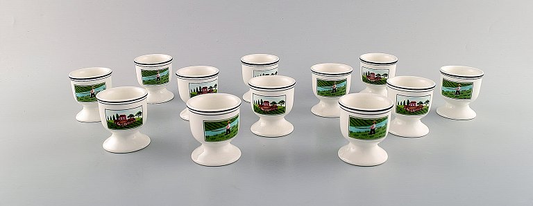Villeroy & Boch Naif dinner service in porcelain. A set of 16 egg cups decorated 
with naivist village motifs.