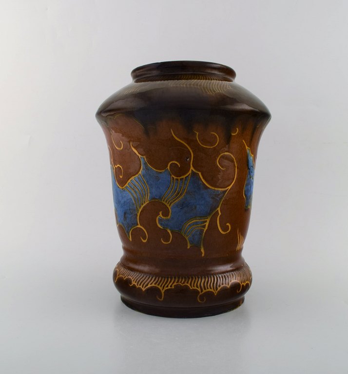 Møller & Bøgely, Denmark. Large art nouveau vase in glazed ceramics. Beautiful 
glaze in brown and blue shades. Ca. 1920.
