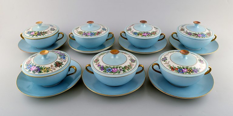 Seven early Bing and Grondahl boullion cups with lids and saucers. Hand painted 
gold and floral decoration on turquoise background. Overglaze. Ca. 1910.
