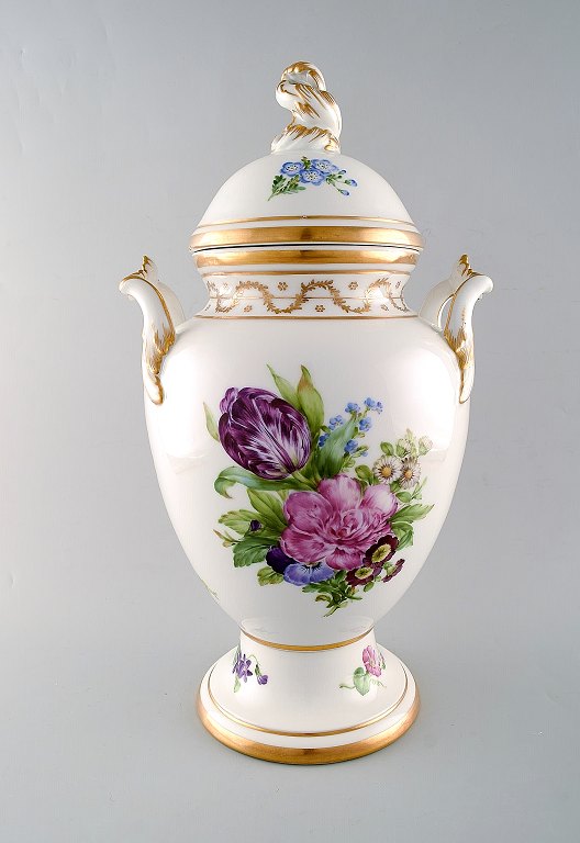 Royal Copenhagen. Antique baluster shaped porcelain lidded vase. Hand painted in 
colors with flowers. knob in the form of rocaille and handle in the form of 
leaf. Museum Quality. 19th century.
