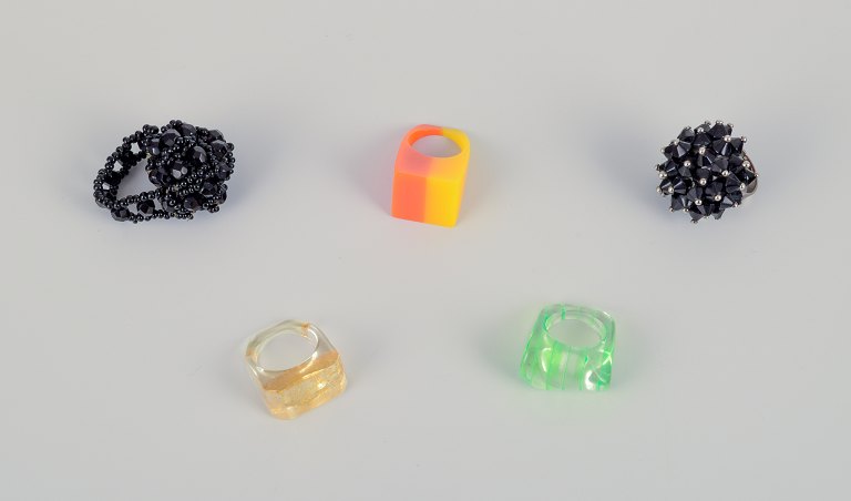 French jewelry artist. Five designer rings in plastic and metal. Striped design 
with various colors and black beads.