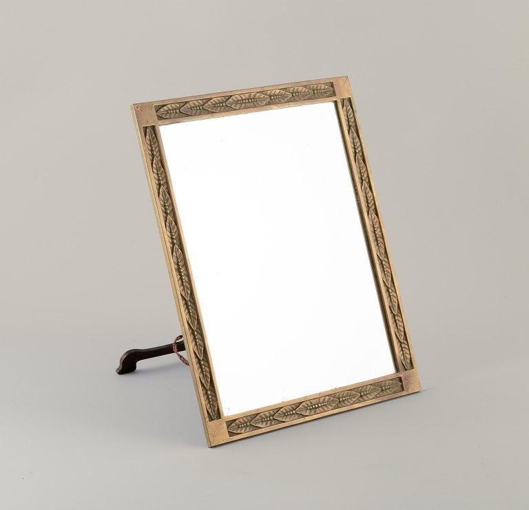 German designer. Art Nouveau table mirror in brass.