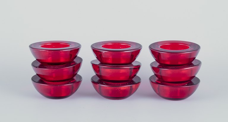 Scandinavian glass artist. A set of nine candle holders.